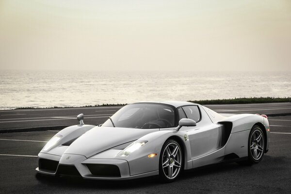 Silver Ferrari Enzo near the sea