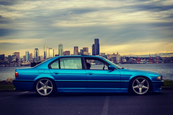 Blue silver BMW on the city embankment