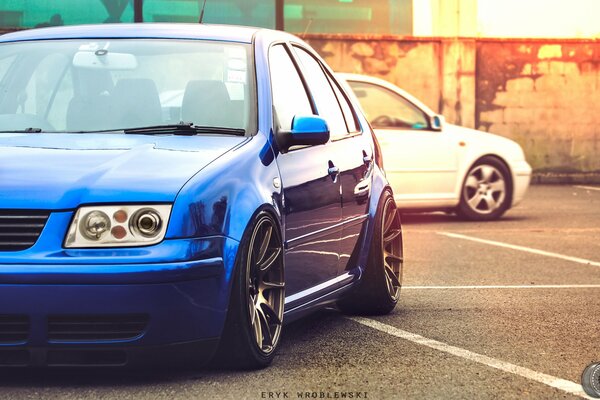 Blue car on the background of a white car