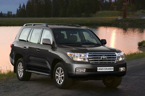 Toyota land cruiser on the background of the evening lake