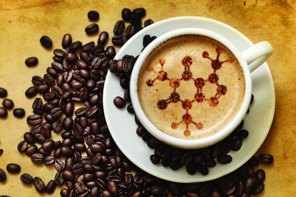 A cup of coffee with a fancy pattern on the foam