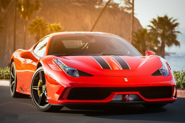 A brutal Ferrari accelerates with a roar and a squeal on the seashore