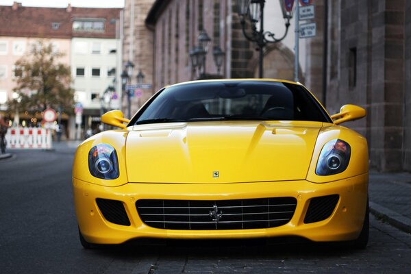 Yellow Ferrari supercar in the middle of the city