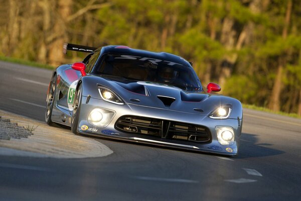 Silver sports car in motion