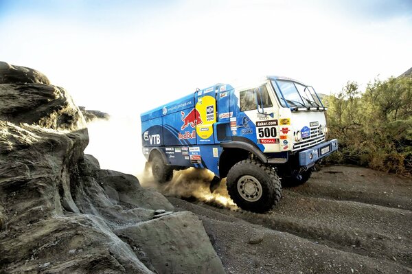 Kamaz is driving on a dusty road