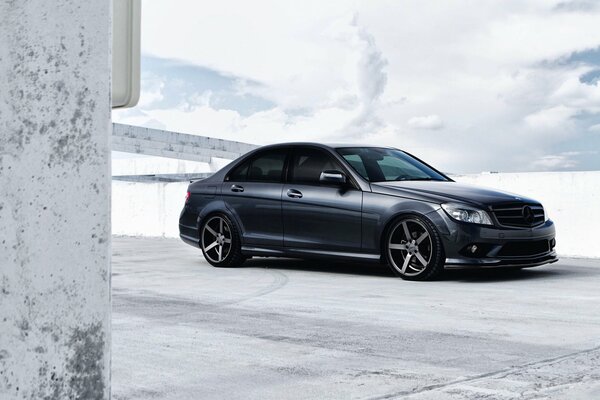 Black Mercedes Benz on a white concrete background