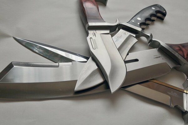 The blades of steel knives lie on top of each other