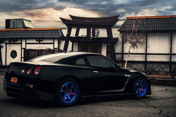 Nissan with bright blue wheels