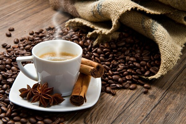 Aromatic coffee with cinnamon on the background of grains