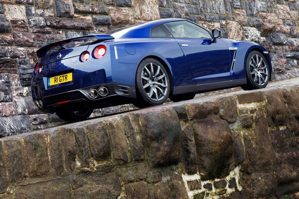 Blue nissan car on a mountain road