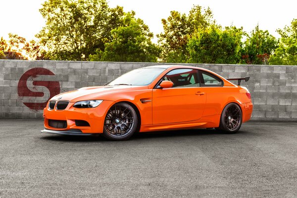 Car orange on the background of green trees