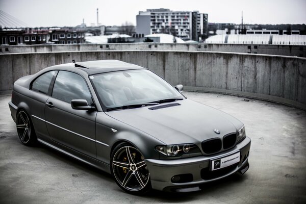 Tuned BMW e46 on the background of the city