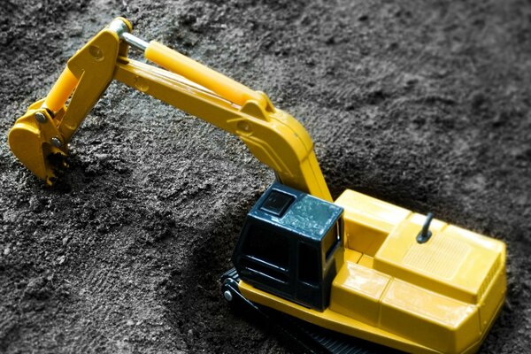 Yellow Toy Excavator in the ground