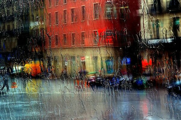 Glass in raindrops on the background of a city street