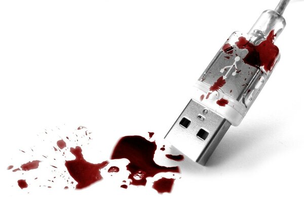 USB squarcio e gocce di sangue su sfondo bianco