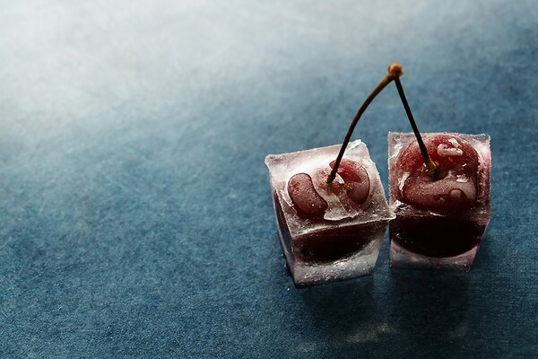 Two frozen cherries on the table