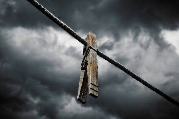 CLOTHESPIN AND THE SKY WITH GLOOMY CLOUDS