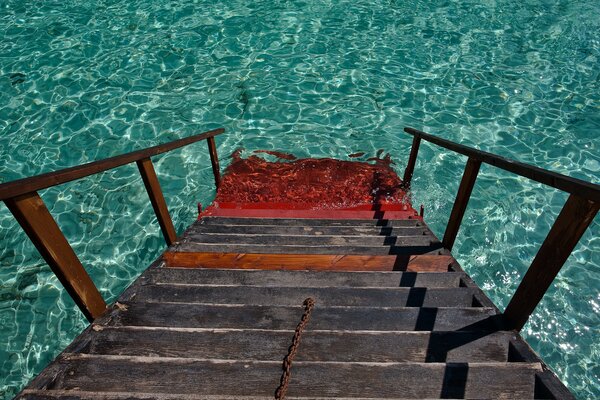 Las escaleras descienden al agua clara y profunda