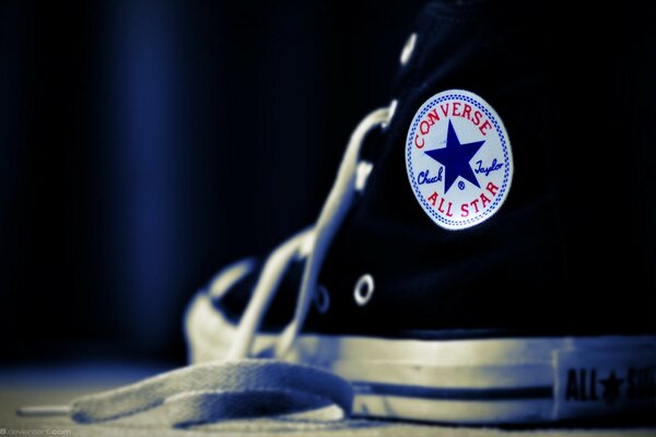 A star on sneakers with untied laces