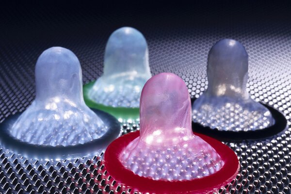 Multicolored condoms on a dark background