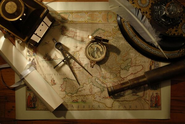 The telescope, compass and pen are on the map