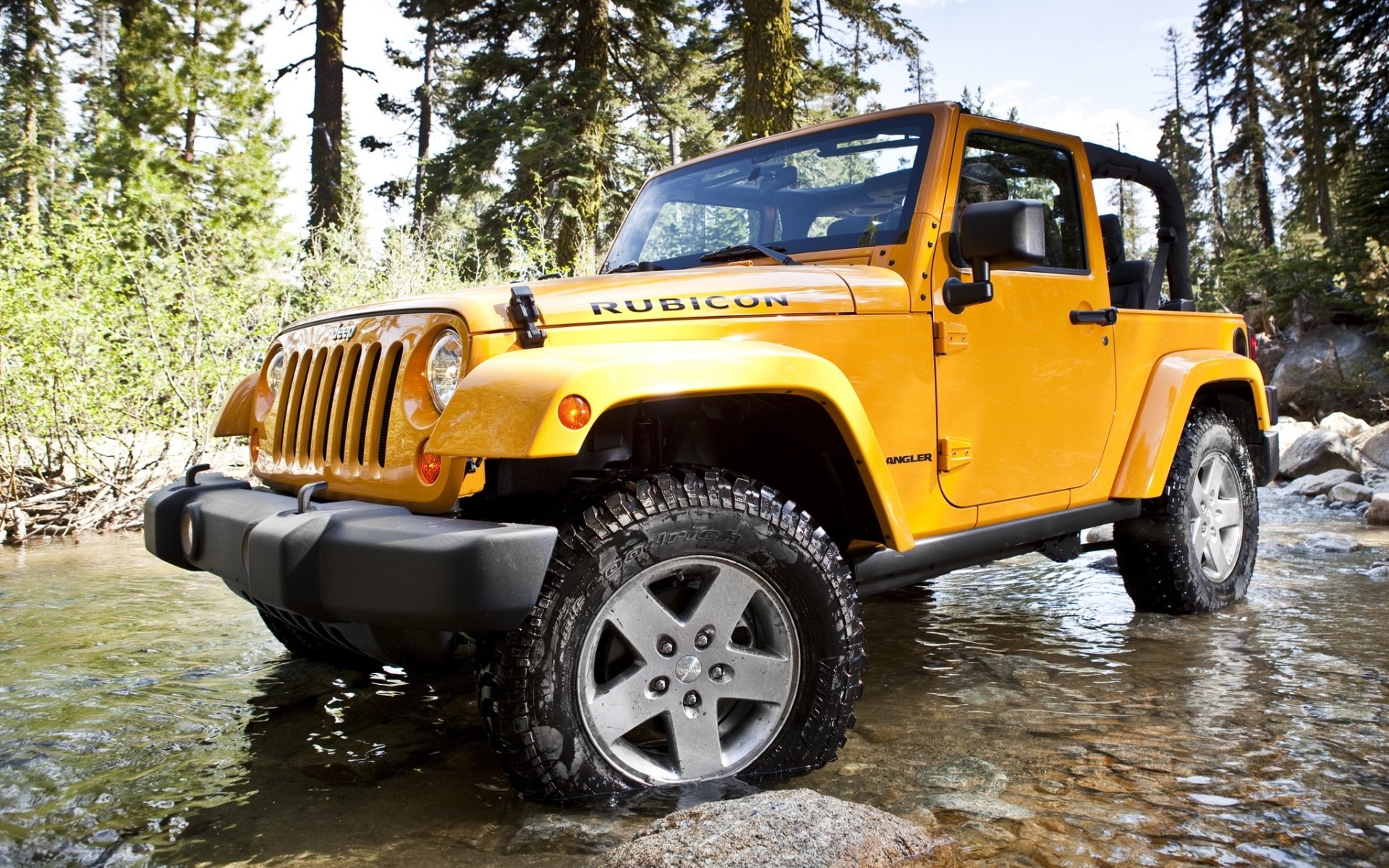 jeep wrangler rangler rubicon suv front end forest trees rocks ford water