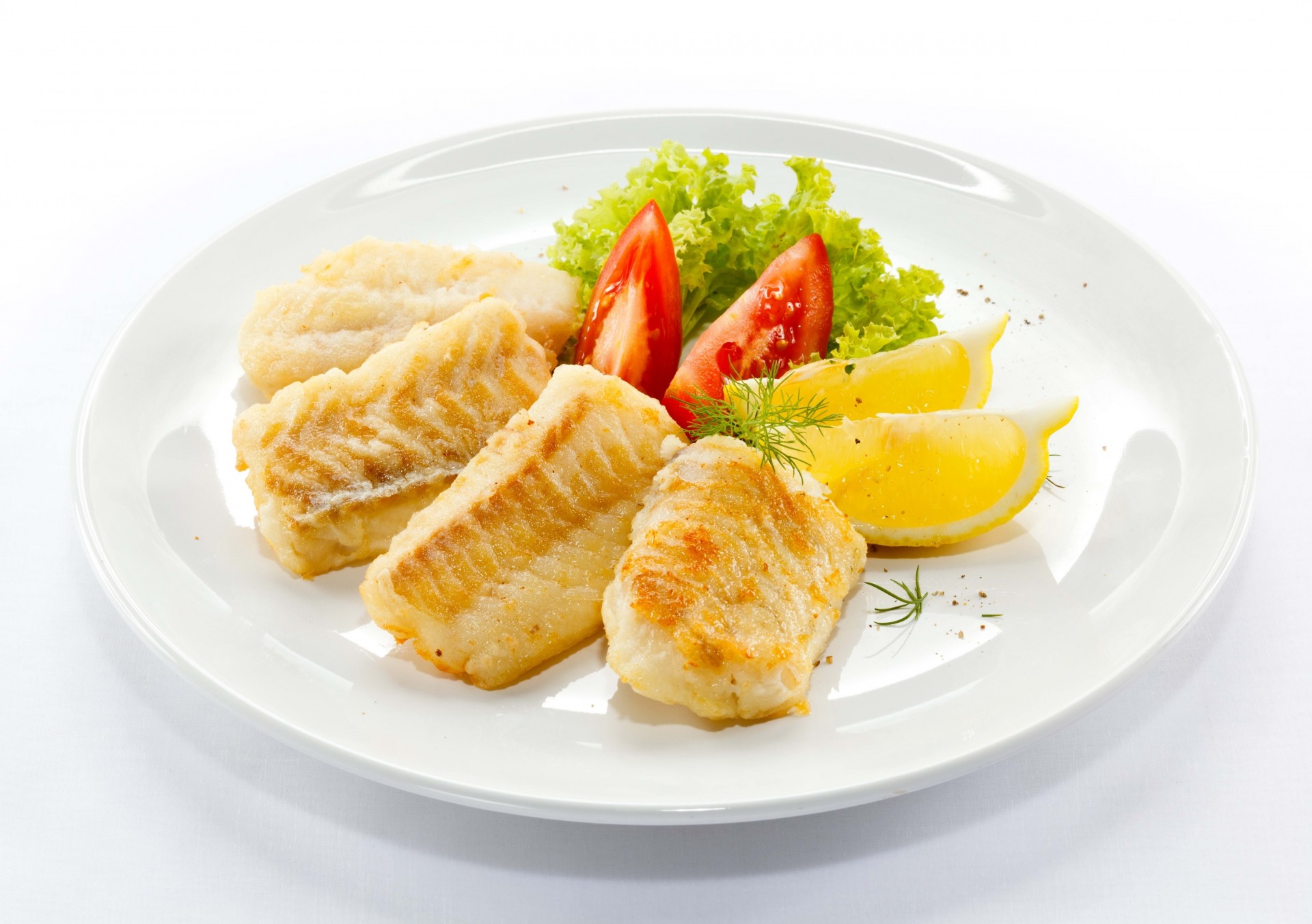 egments lemon tomato white background plate fish cabbage