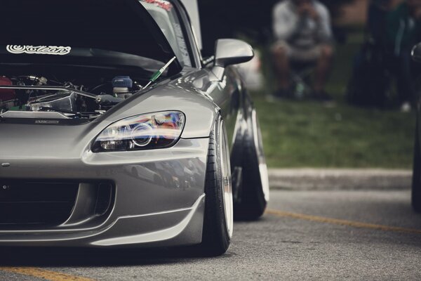 Japanese sports car with extended wheels, in a beautiful gray color