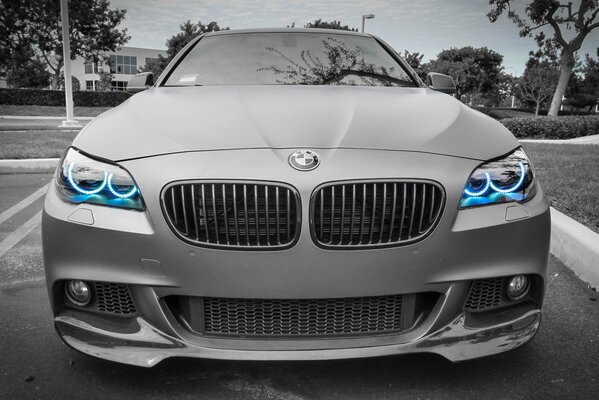 Grey bmw car with blue neon headlights