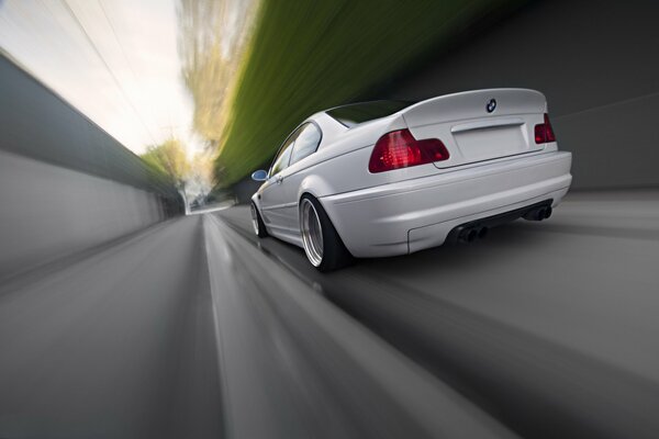 Stylish white BMW rushes down the road