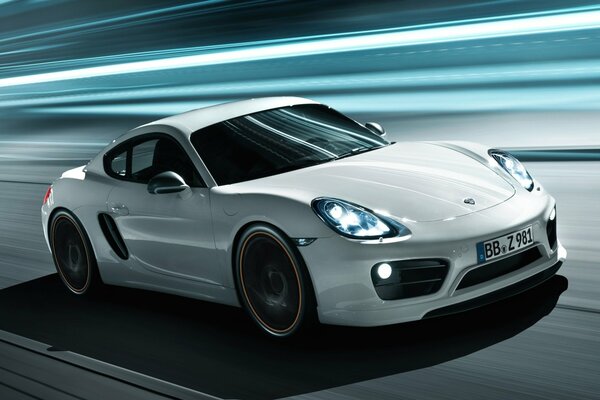 Porsche techart cayman rides at high speed