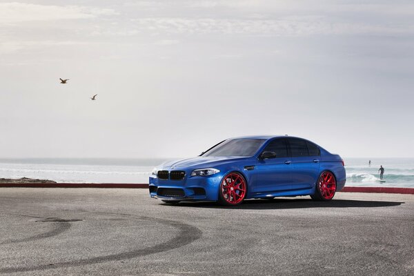 Blue BMW on a deserted coast