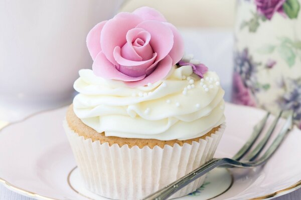 White delicate cake with a rose at the top