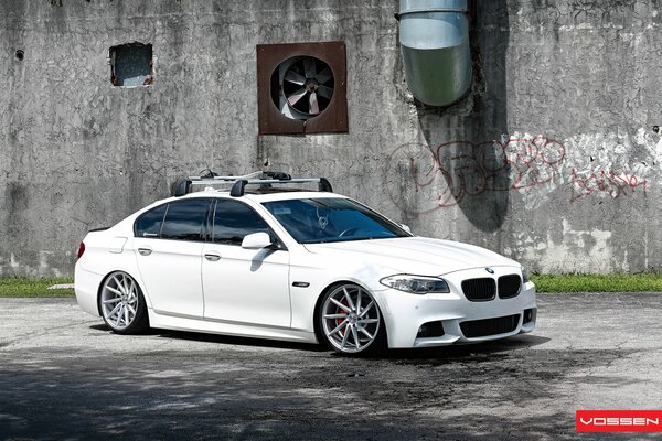 White BMW on a gray wall background