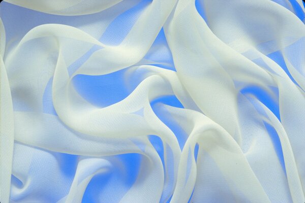 Texture white silk on a blue background