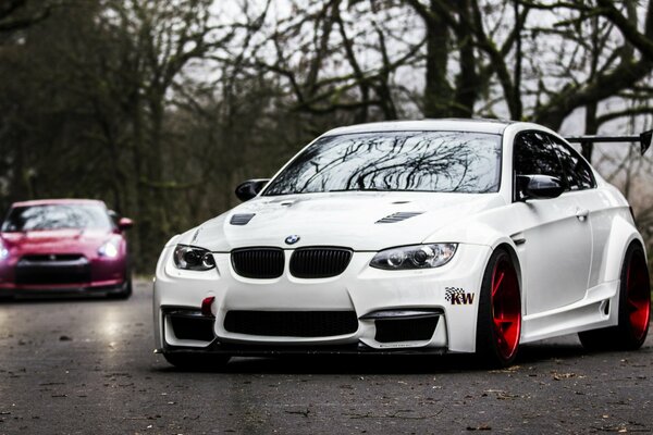 White BMW on the autumn road