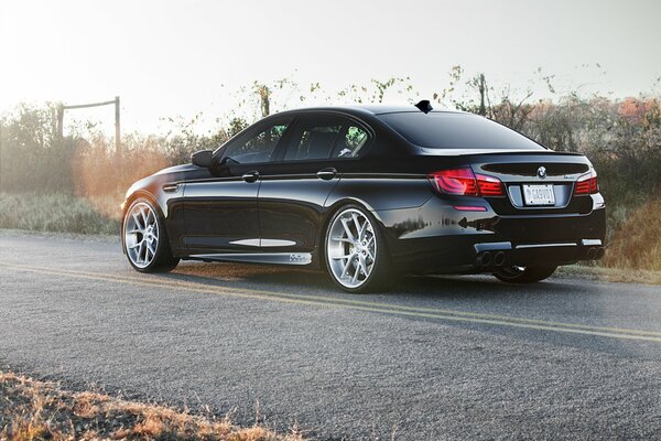 Black BMW on the road with markings