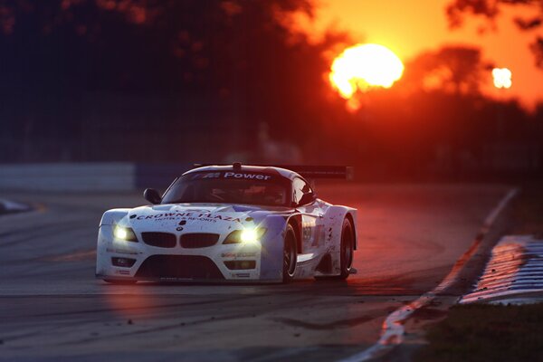 Skidding on a turn in the twilight against the background of sunset