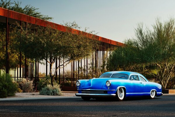 Blue retro Chevrolet on sunset background