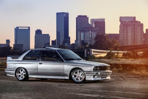 Silver BMW on the background of skyscrapers