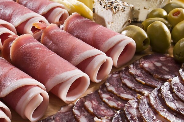 Sliced sausage and ham with olives