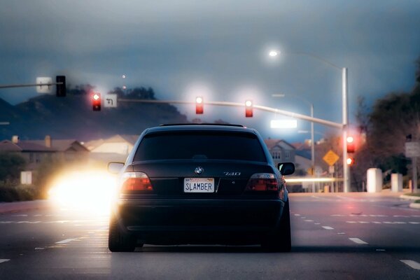 A black boomer stopped at a traffic light - rear view