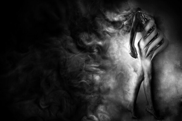 The figure of a girl in black and white smoke