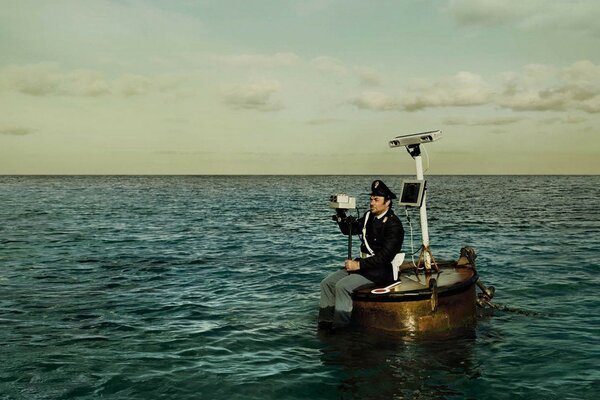 Traffic police inspector on a barrel in the sea with radar