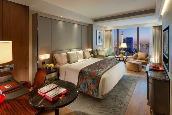 Bedroom with a large bed and floor-to-ceiling windows