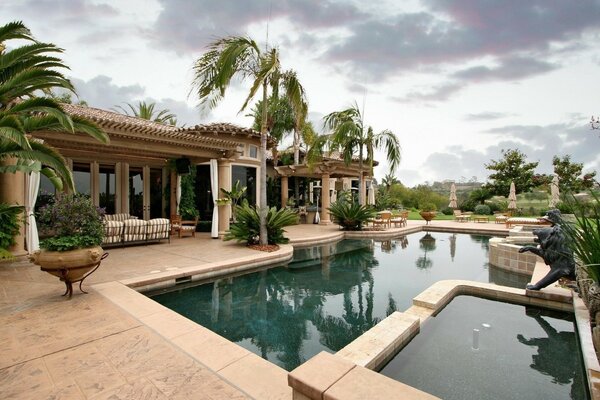 Villa with pool on the background of palm trees and nature