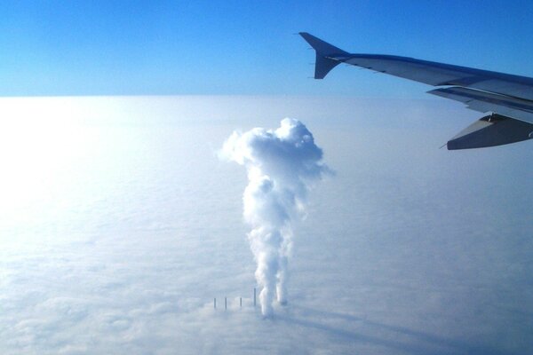 Landscape of a flying plane. Smoking pipe