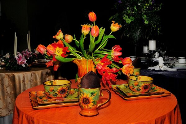 Tables with flowers and bright cups