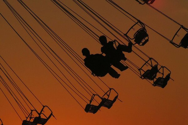 Carousel at sunset. Two people