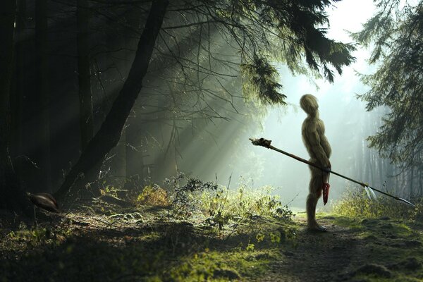 A hairy warrior with a spear in the forest